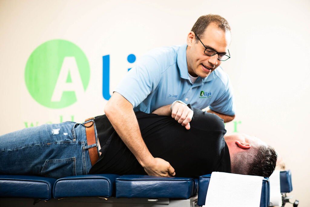 Dr Gerstin performing chiropractic adjustment on male patient